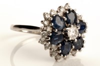 Lot 790 - A diamond and sapphire cluster ring, the...