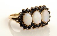 Lot 792 - An opal and sapphire ring, the three oval...