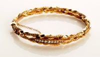 Lot 796 - A yellow metal 19th Century bangle, of double...