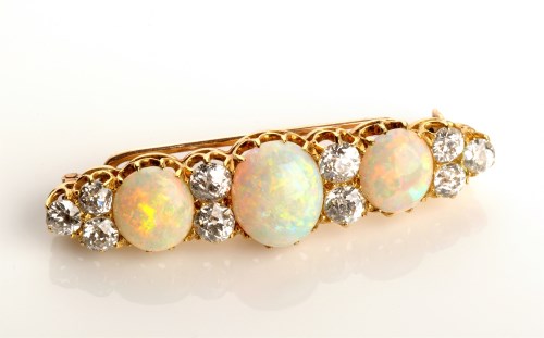Lot 802 - A Victorian opal and diamond brooch, the three...