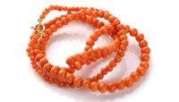 Lot 806 - A coral bead necklace, the graduated single...