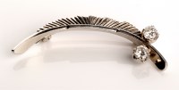 Lot 807 - A 9ct. white gold diamond set feather pattern...