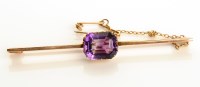 Lot 811 - An amethyst and yellow metal bar brooch, the...