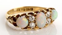 Lot 814 - An opal and diamond ring, c.1903, the central...