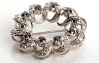 Lot 818 - A sapphire and diamond wreath pattern brooch,...