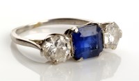 Lot 820 - A sapphire and diamond ring, the central...