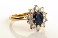 Lot 822 - A sapphire and diamond cluster ring, the...