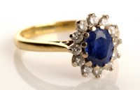 Lot 823 - A sapphire and diamond cluster ring, the...