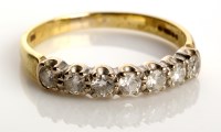 Lot 825 - A seven stone diamond ring, each brilliant cut...