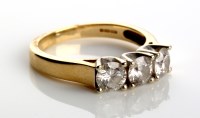 Lot 829 - A three stone diamond ring, each stone claw...