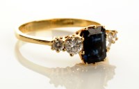 Lot 846 - A sapphire and diamond ring, the central...