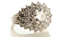 Lot 849 - A diamond cluster dress ring, the central...