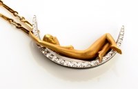 Lot 851 - A diamond set 18ct. gold crescent moon pendant,...