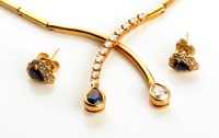 Lot 853 - A diamond and sapphire set 18ct. gold necklace,...