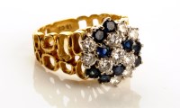 Lot 861 - A diamond and sapphire cluster ring, with nine...