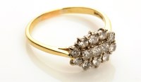 Lot 871 - A diamond cluster ring, the three central...