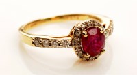 Lot 876 - A ruby and diamond cluster ring, the central...