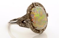 Lot 880 - An Art Deco opal and diamond cluster ring, the...