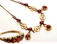 Lot 883 - A 9ct. yellow gold and garnet necklace, with...