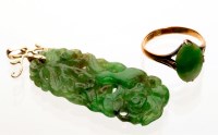 Lot 890 - A 19th Century carved green stone pendant,...