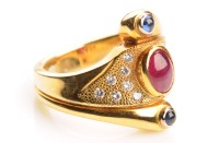 Lot 899 - A ruby, sapphire and diamond ring, the central...