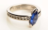 Lot 900 - A sapphire and diamond ring, the central...