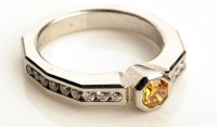 Lot 902 - An orange and colourless diamond ring, the...