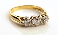 Lot 911 - A three stone diamond ring, each brilliant cut...