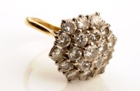 Lot 913 - A diamond cluster dress ring, the nineteen...