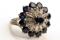 Lot 915 - A sapphire and diamond dress ring, the central...