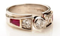 Lot 924 - A diamond and ruby ring, the central diamond...