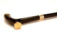 Lot 1157 - An ebony walking cane with yellow metal mount,...