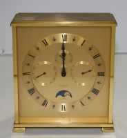 Lot 1210 - Looping: a modern brass mantel clock, with...