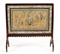 Lot 1259 - A mahogany framed firescreen with ornate...