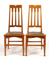 Lot 1283 - A pair of honey oak Arts & Crafts chairs, the...