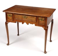 Lot 1288 - A George III rectangular oak lowboy, the three...