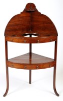 Lot 1317 - A George III mahogany corner washstand, with...