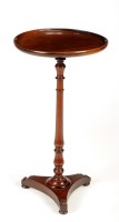 Lot 1326 - A circular mahogany wine table, raised on a...