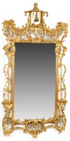 Lot 1331 - A rococo design wall mirror with ornate leaf...