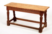 Lot 1339 - An antique rectangular oak stool with carved...