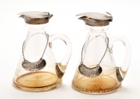 Lot 589 - Two George V glass and silver mounted whisky...