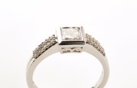 Lot 747 - A diamond ring, the central princess cut...