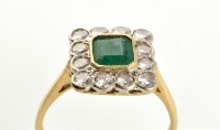 Lot 748 - An emerald and diamond cluster ring, the...