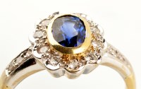 Lot 757 - A sapphire and diamond cluster ring, the...