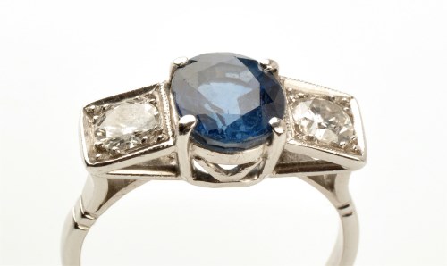 Lot 780 - A sapphire and diamond ring, the oval facet...