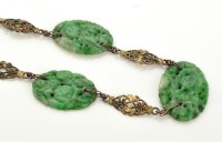 Lot 794 - A carved jadeite and white metal necklace,...