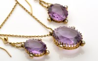 Lot 795 - An amethyst and seed pearl pendant with...