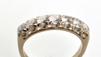 Lot 822 - A diamond half hoop eternity ring, the seven...