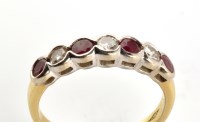 Lot 828 - A ruby and diamond ring, the four circular...