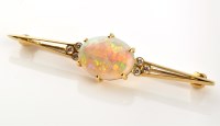 Lot 831 - An opal and diamond bar brooch, the oval opal...